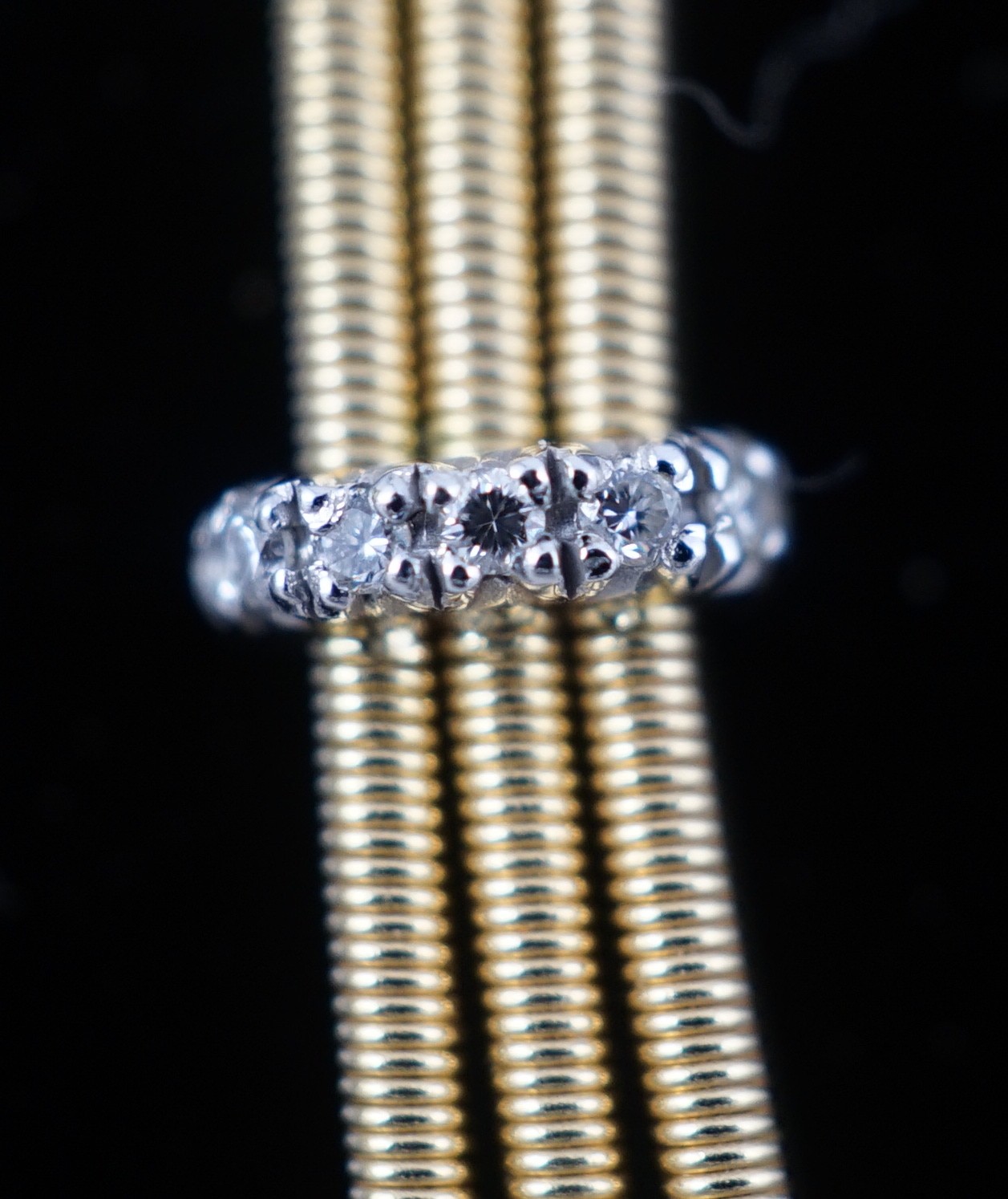 A modern Italian Marco Bicego 18ct gold and eleven stone diamond chip set triple strand necklace